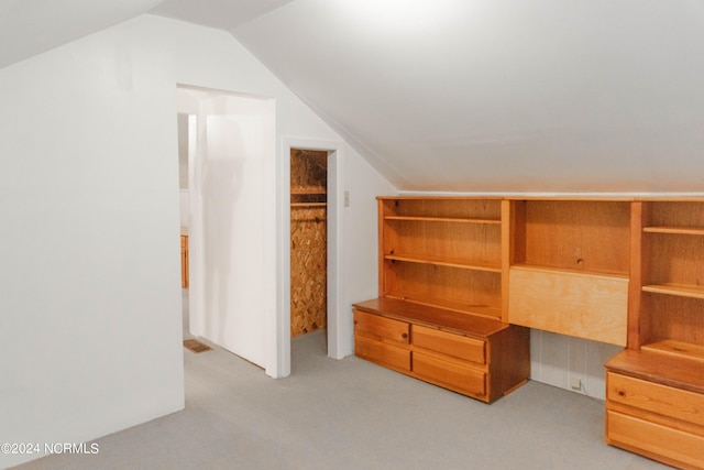 interior space featuring light carpet and lofted ceiling