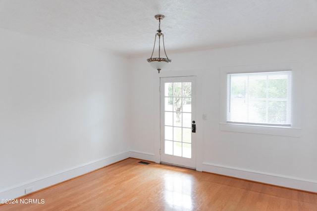 entryway featuring a textured ceiling and hardwood / wood-style flooring