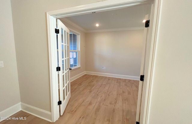 interior space featuring ornamental molding and light hardwood / wood-style floors