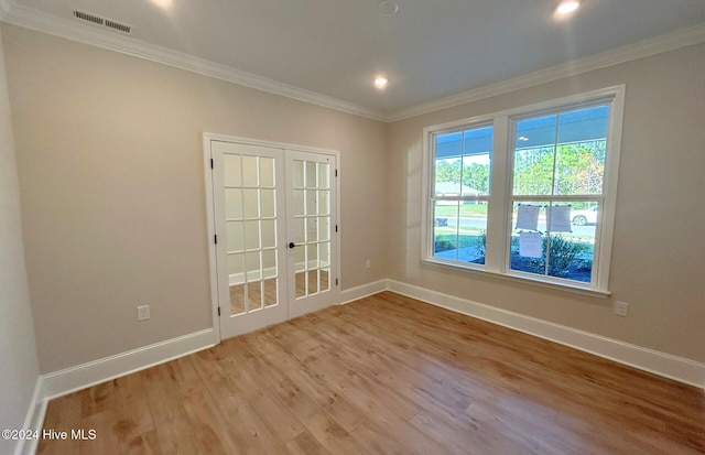 unfurnished room featuring crown molding, light hardwood / wood-style floors, and french doors