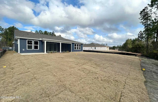 back of house featuring a yard