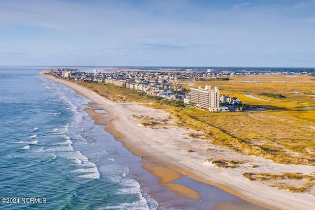 birds eye view of property featuring a beach view and a water view