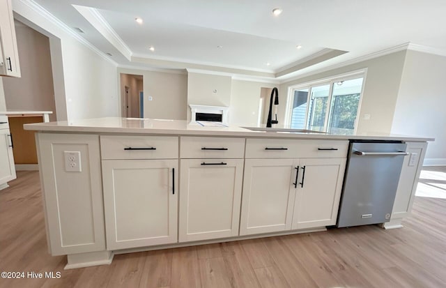 kitchen with white cabinetry, sink, a tray ceiling, and a kitchen island