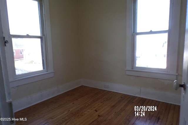 empty room with dark hardwood / wood-style floors