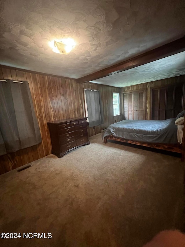 unfurnished bedroom featuring carpet floors and wooden walls