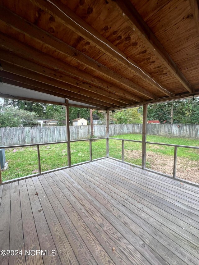 unfurnished sunroom with beamed ceiling and wooden ceiling