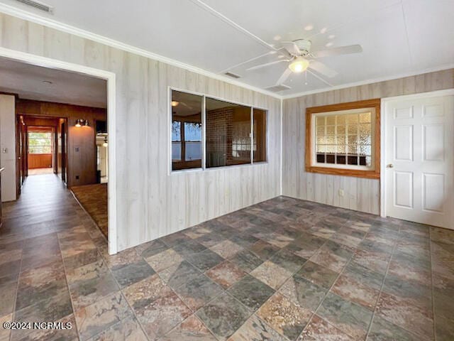 empty room with wooden walls and ceiling fan