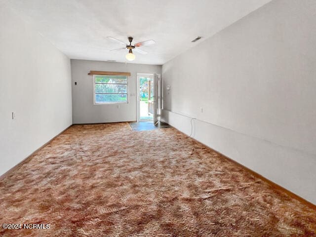 spare room with ceiling fan and carpet