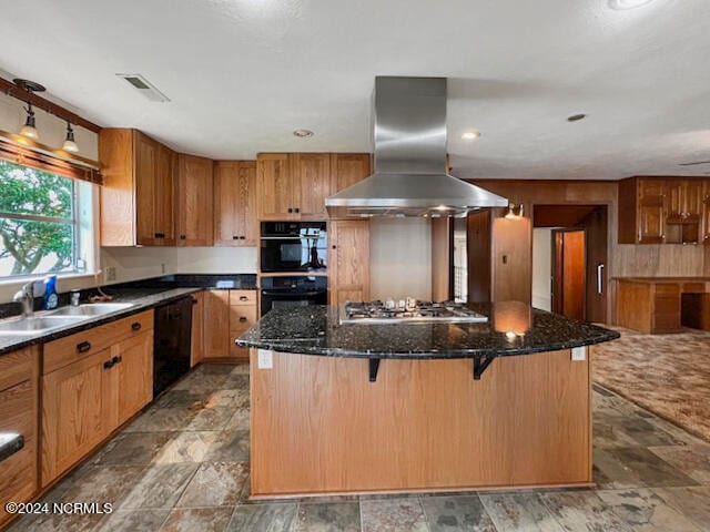 kitchen with a breakfast bar, wall chimney exhaust hood, black appliances, a center island, and dark stone countertops