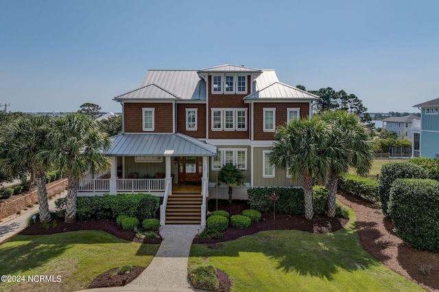 view of front of house featuring a front yard and a porch