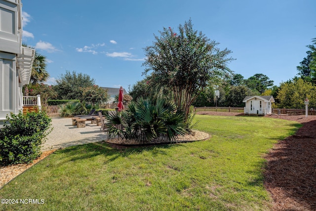 view of yard featuring an outdoor structure and a patio