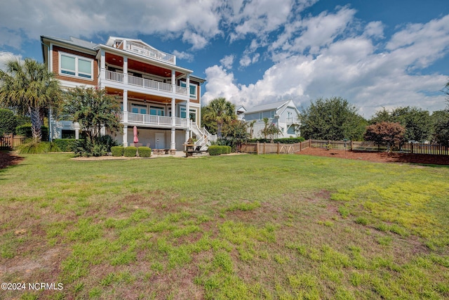 view of yard with a balcony