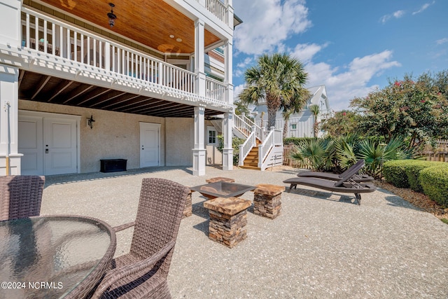 view of patio / terrace with ceiling fan and a fire pit