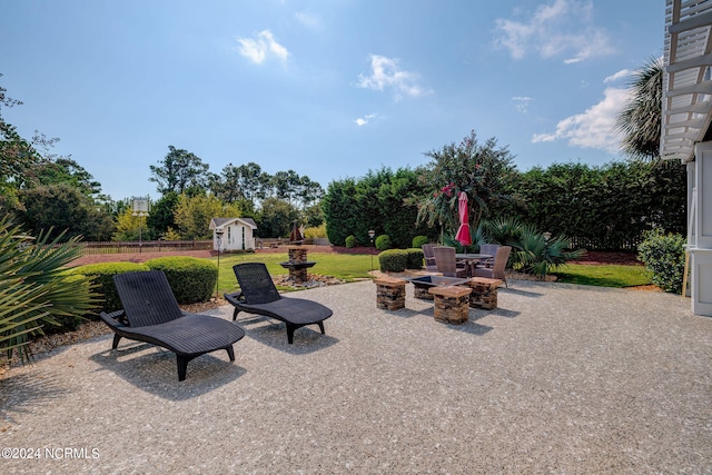 view of patio / terrace featuring a storage unit and an outdoor fire pit