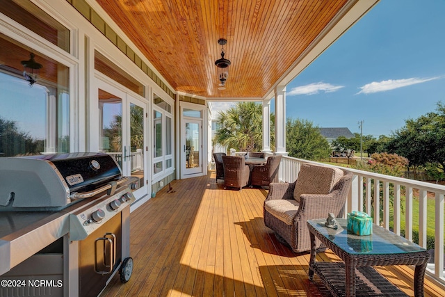 deck featuring french doors and a grill