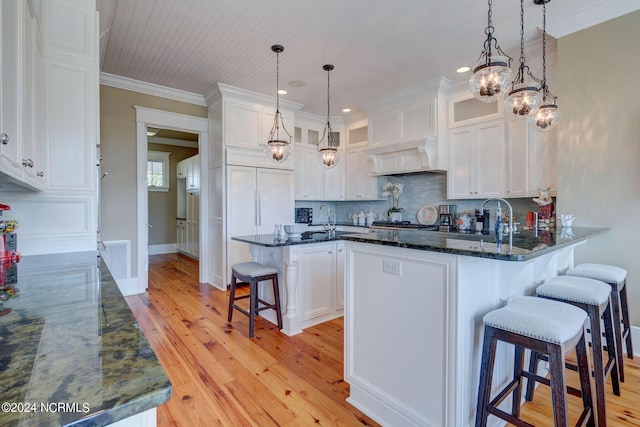kitchen with white cabinets and light wood-type flooring