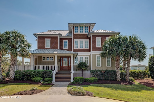 view of front of property featuring covered porch and a front yard