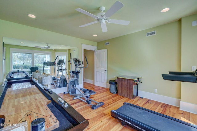 workout room featuring wood-type flooring and ceiling fan