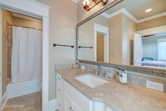 full bathroom featuring shower / bath combo with shower curtain, vanity, crown molding, and toilet