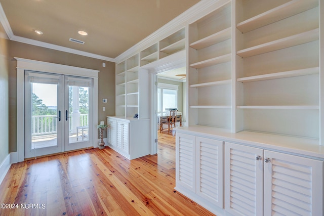 doorway to outside with light wood-type flooring, crown molding, and french doors