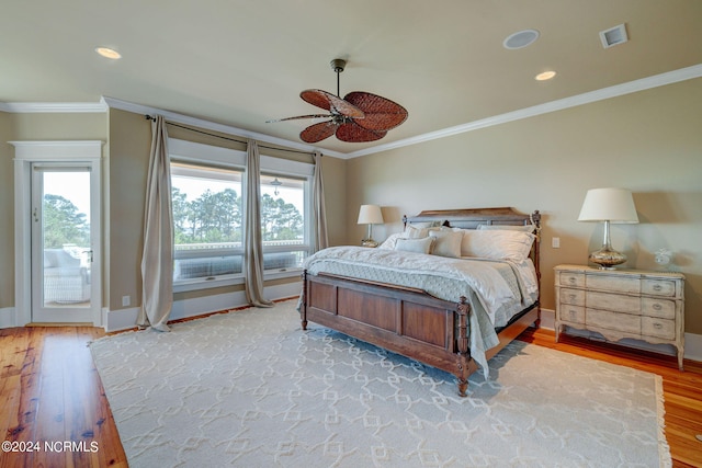 bedroom featuring wood-type flooring, ceiling fan, multiple windows, and crown molding