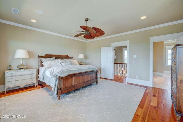 bedroom featuring crown molding, hardwood / wood-style floors, and ceiling fan