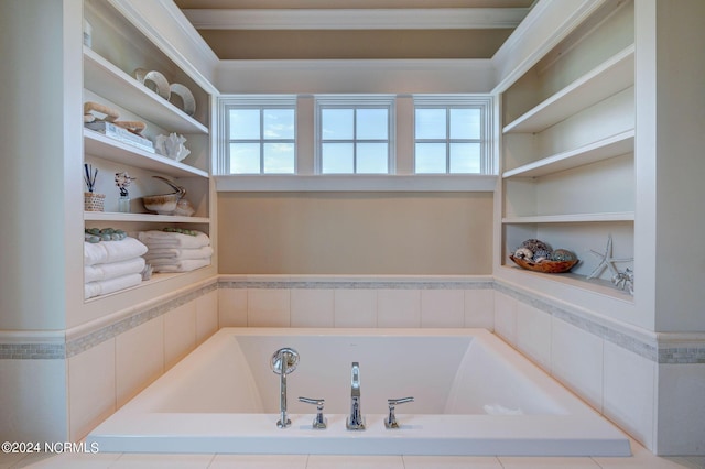 bathroom with a bath, a wealth of natural light, and crown molding