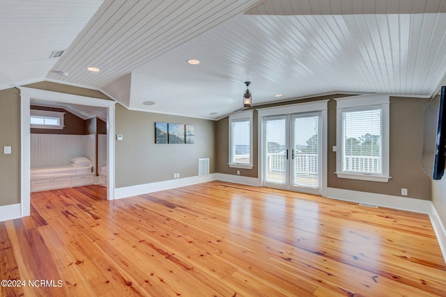 unfurnished living room featuring light hardwood / wood-style floors, wooden ceiling, and a healthy amount of sunlight