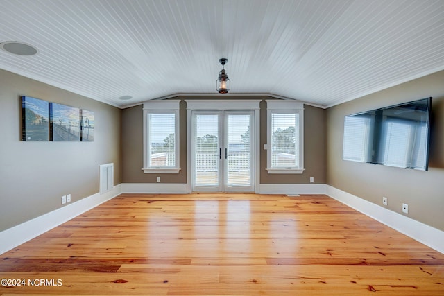 interior space featuring light wood-type flooring, vaulted ceiling, wooden ceiling, and french doors