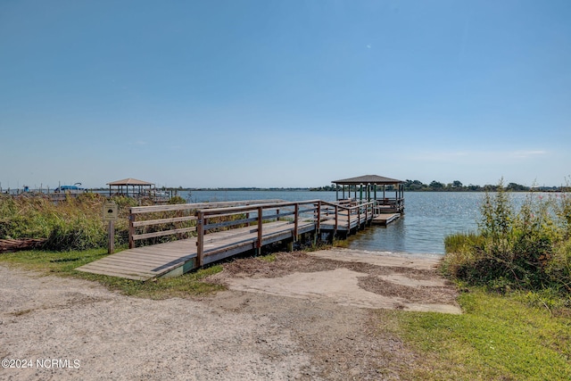 view of dock with a water view and a gazebo