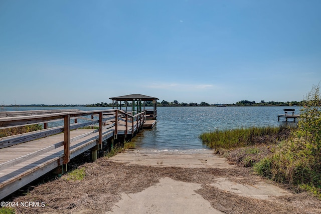 dock area with a gazebo and a water view