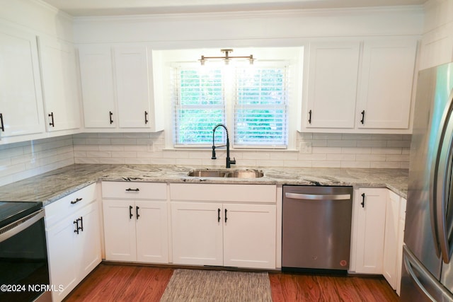 kitchen with white cabinets, appliances with stainless steel finishes, dark hardwood / wood-style floors, and sink