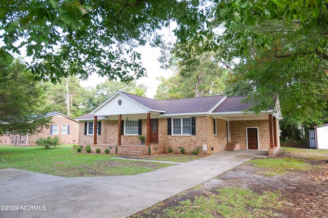 ranch-style home with a front yard and a carport