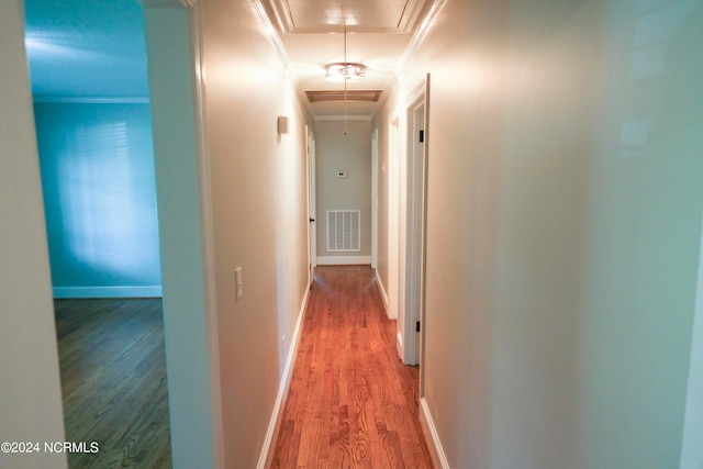 hall featuring ornamental molding and hardwood / wood-style flooring