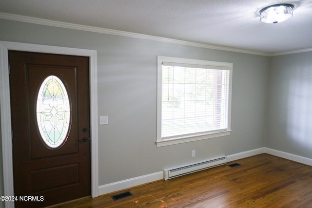 foyer with baseboard heating, dark hardwood / wood-style floors, and ornamental molding