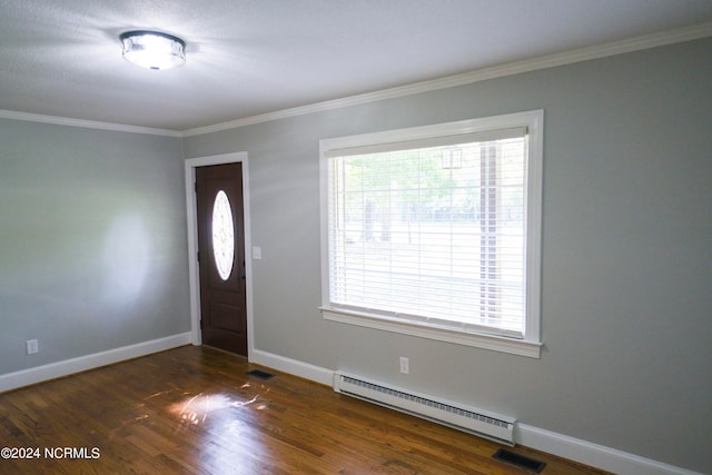 entryway with ornamental molding, a baseboard heating unit, and dark hardwood / wood-style flooring