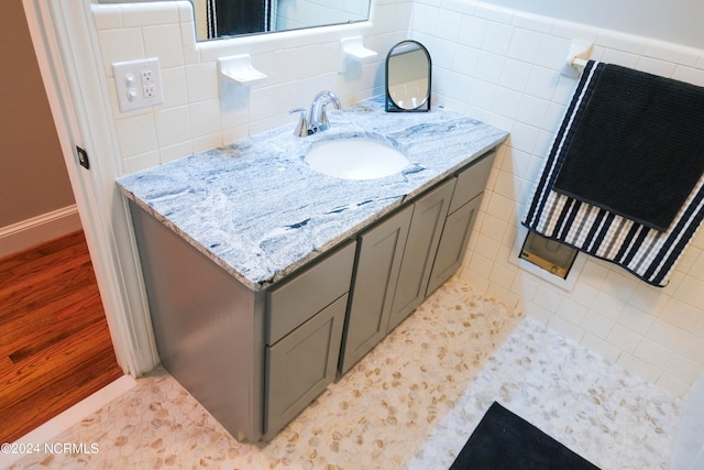 bathroom featuring tile walls and vanity