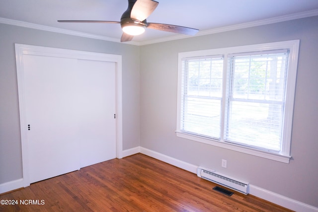 empty room with a healthy amount of sunlight, dark wood-type flooring, and ceiling fan