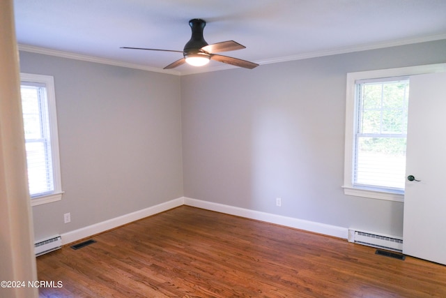 spare room featuring plenty of natural light, a baseboard heating unit, ceiling fan, and hardwood / wood-style flooring