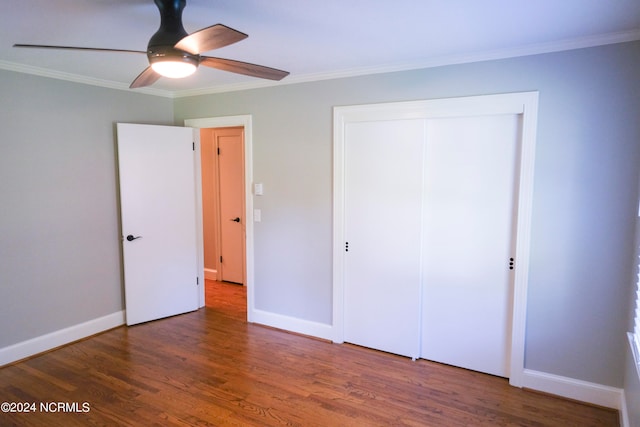 unfurnished bedroom with ceiling fan, a closet, crown molding, and dark hardwood / wood-style flooring