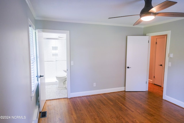 unfurnished bedroom featuring ceiling fan, multiple windows, and dark wood-type flooring