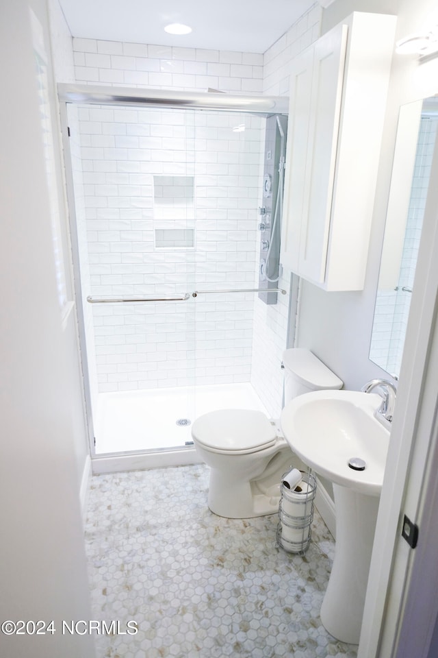 bathroom featuring toilet and an enclosed shower