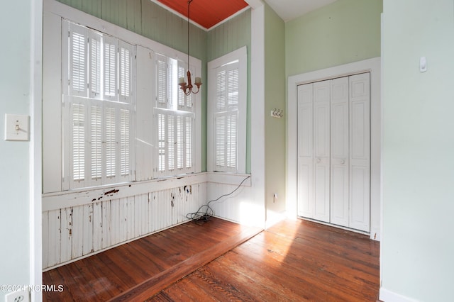 interior space with a notable chandelier, dark hardwood / wood-style flooring, and a healthy amount of sunlight