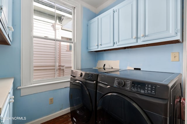 washroom with separate washer and dryer, cabinets, and dark hardwood / wood-style flooring