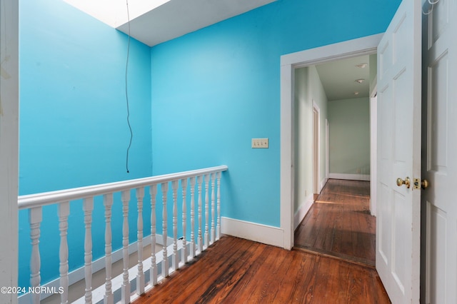 corridor with dark hardwood / wood-style flooring