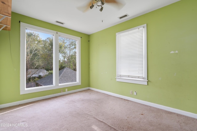 carpeted spare room with ceiling fan