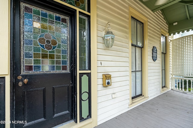 view of exterior entry with covered porch