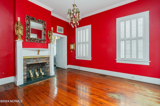 unfurnished living room featuring a notable chandelier, ornamental molding, and hardwood / wood-style flooring