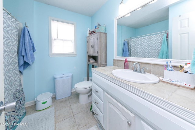 bathroom featuring tile patterned flooring, vanity, and toilet