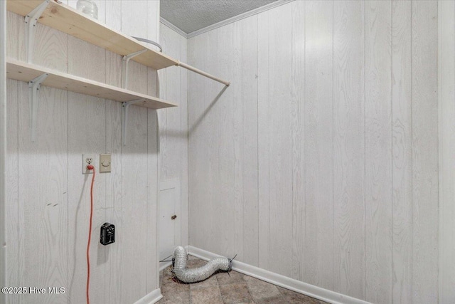 washroom featuring hookup for a washing machine, ornamental molding, and wooden walls